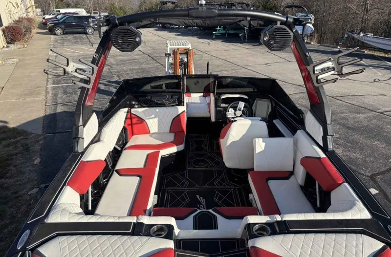Slide: The Image of 2023 Tigé 22RZX boat interior with red and white seating, black accents, and speakers. - 6