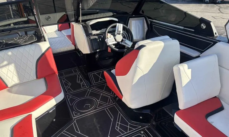 Slide: The Image of 2023 Tigé 22RZX boat interior with red and white seating, modern dashboard, and stylish flooring. - 7