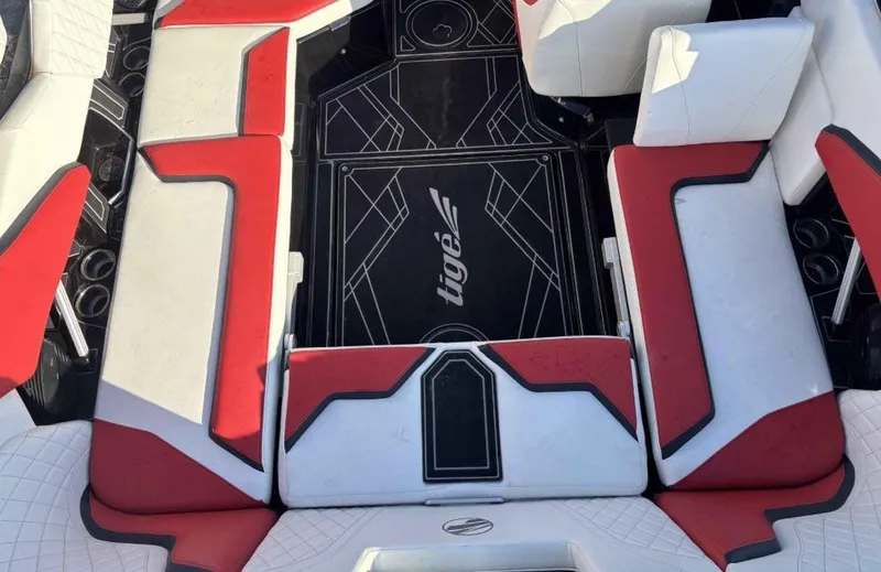 Slide: The Image of 2023 Tigé 22RZX boat interior with red and white seating, featuring stylish design. - 8