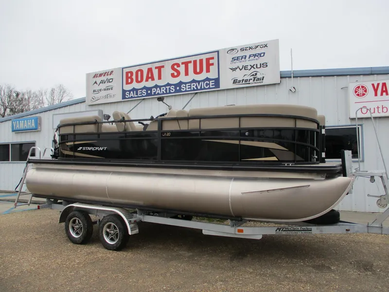 Slide: The Image of 2025 Starcraft LX20 R pontoon boat on trailer at dealership. - 0