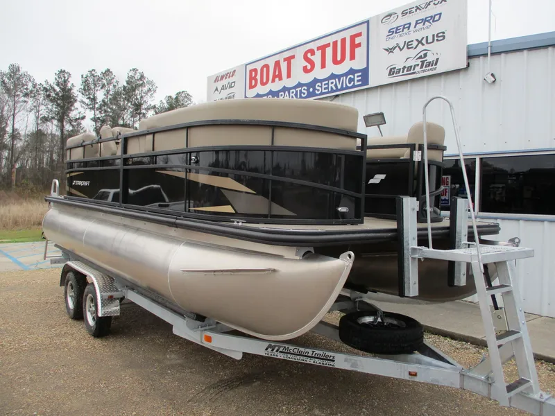 Slide: The Image of 2025 Starcraft LX20 R pontoon boat on trailer at dealership. - 1