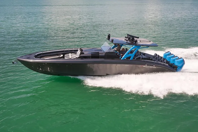 Slide: The Image of 2023 Midnight Express 43' Solstice speedboat cruising on clear green water. - 1