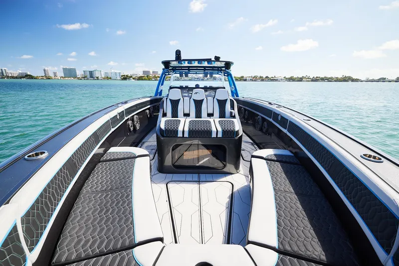 Slide: The Image of 2023 Midnight Express 43' Solstice boat on calm water, showcasing luxury seating and sleek design. - 12