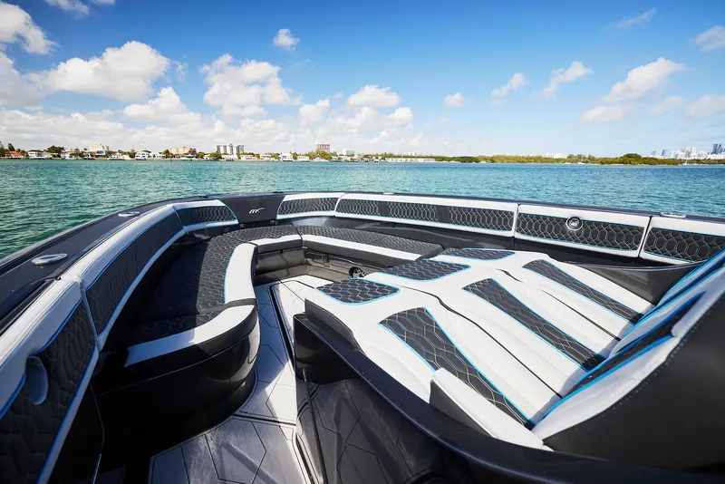Slide: The Image of 2023 Midnight Express 43' Solstice boat interior with luxurious seating on a sunny day. - 13
