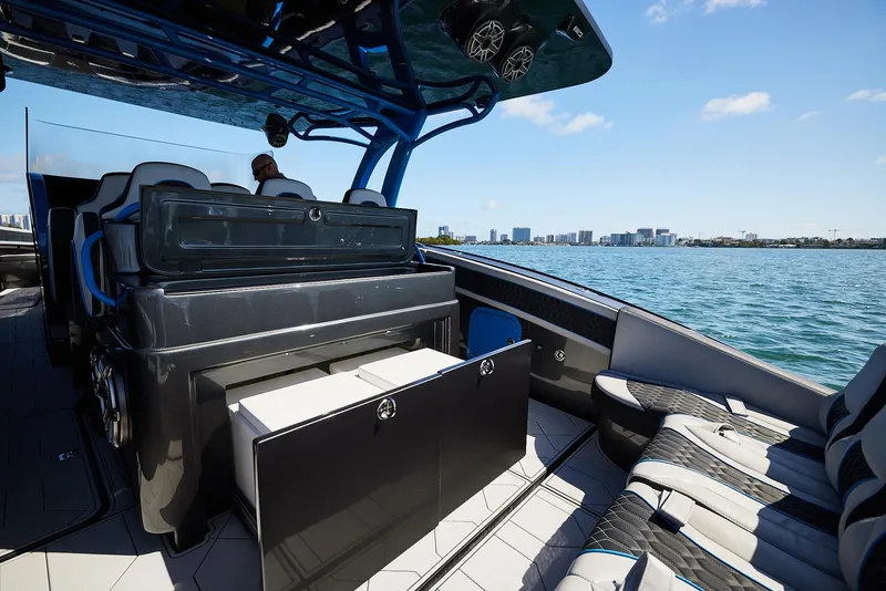 Slide: The Image of 2023 Midnight Express 43' Solstice luxury boat interior with seating, ocean view, and city skyline. - 20