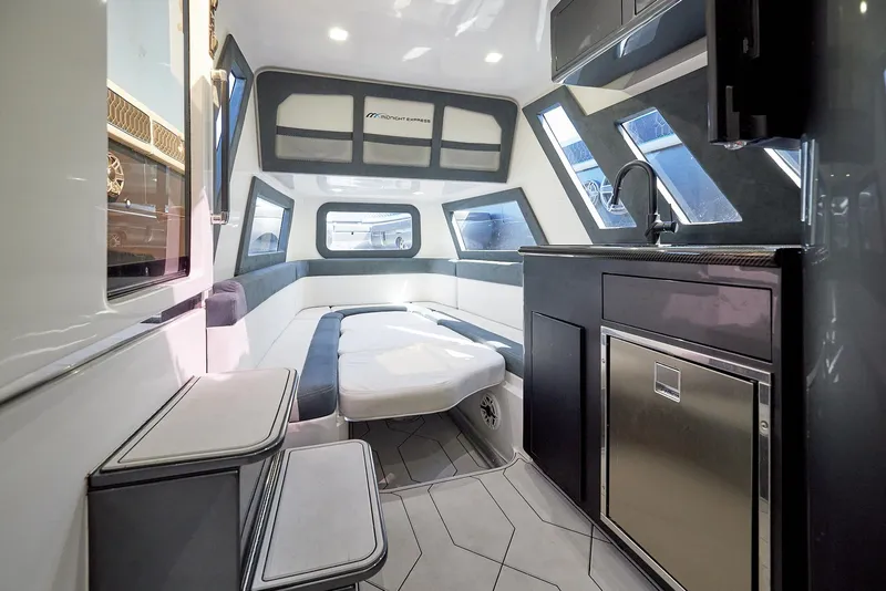 Slide: The Image of Interior of 2023 Midnight Express 43' Solstice yacht, featuring modern seating and kitchenette. - 26