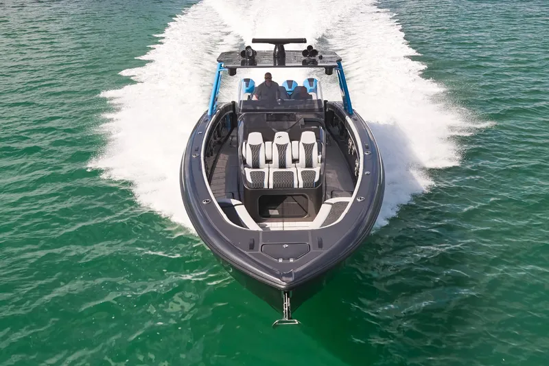 Slide: The Image of 2023 Midnight Express 43' Solstice boat cruising on clear green water. - 5