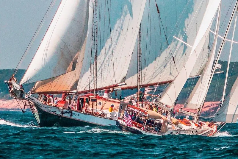 Slide: The Image of Cherubini Schooner 2000 sailing on open sea with full sails and crew. - 12