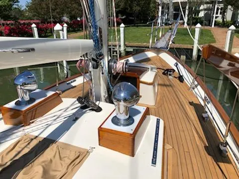 Slide: The Image of Cherubini Schooner 2000 with polished deck fittings and wooden accents docked at a marina. - 18
