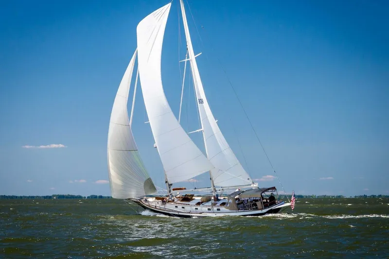 Slide: The Image of Cherubini Schooner 2000 sailing on open water under clear blue skies. - 2