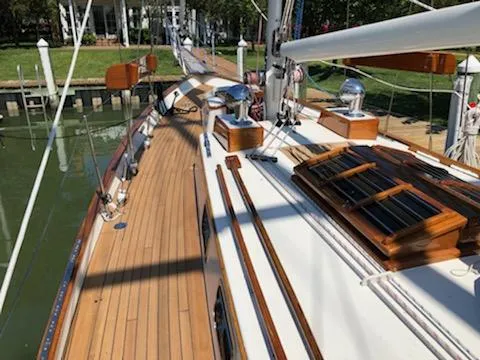 Slide: The Image of Cherubini Schooner 2000 with wooden deck, docked at a marina. - 23