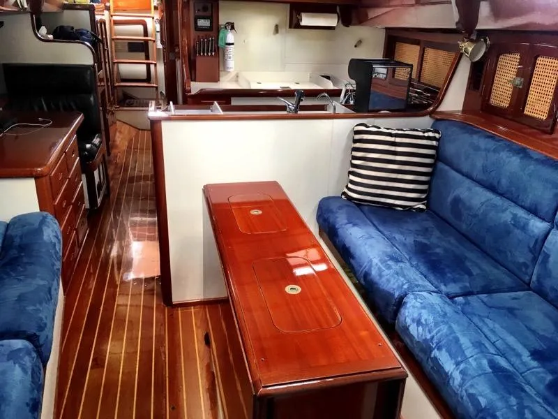 Slide: The Image of Luxurious interior of 2000 Cherubini Schooner with blue seating and polished wood finishes. - 27