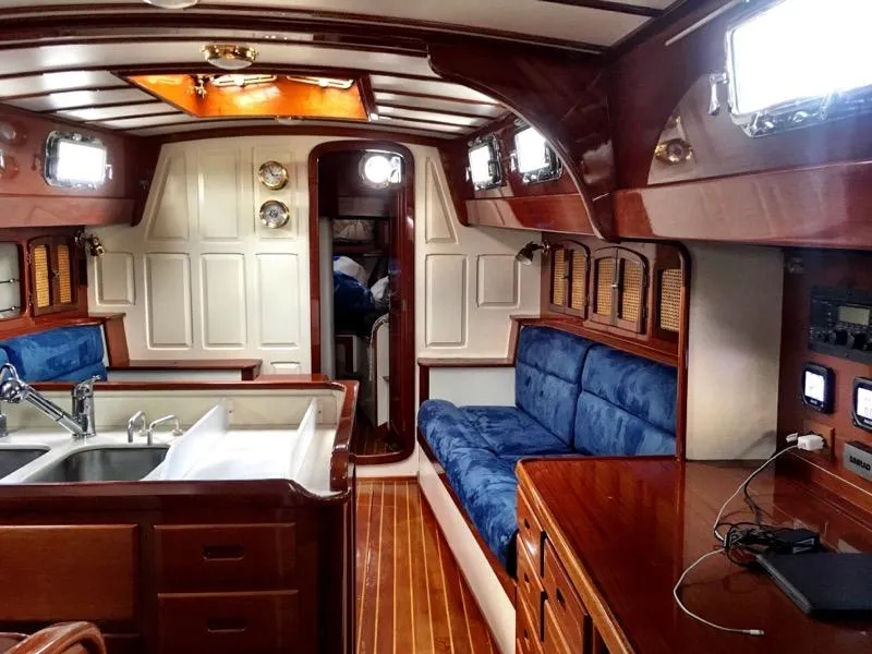 Slide: The Image of Interior of 2000 Cherubini Schooner with wood finish, blue seating, and modern amenities. - 28