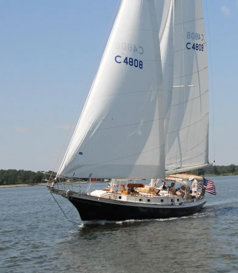 Slide: The Image of Cherubini Schooner 2000 sailing on calm waters with American flag. - 3