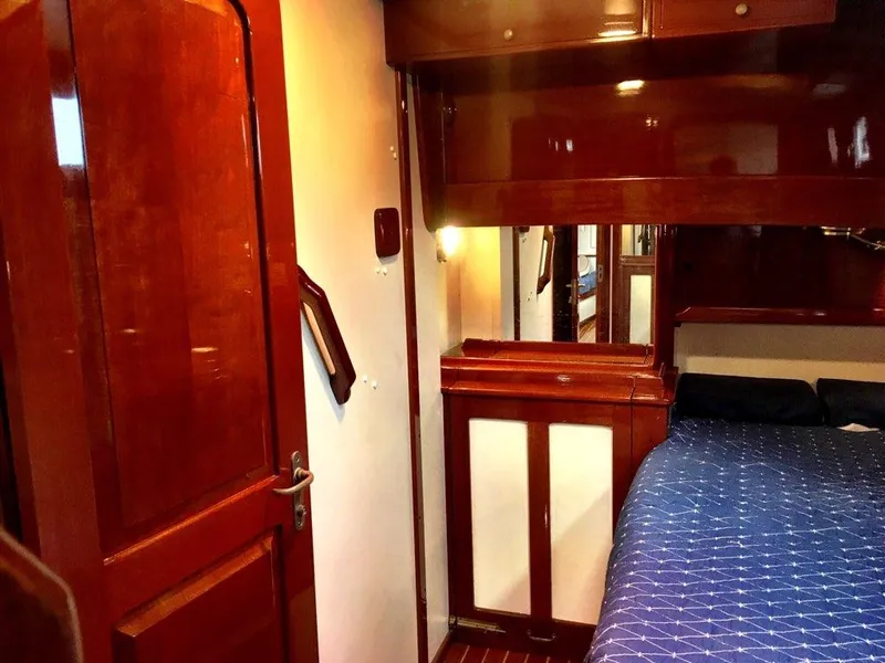 Slide: The Image of Interior of 2000 Cherubini Schooner with polished wood and cozy bedding. - 31