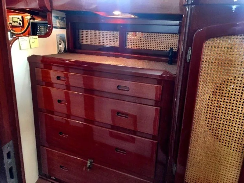Slide: The Image of Interior of 2000 Cherubini Schooner with polished wood drawers and woven cabinet accents. - 32