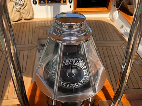 Slide: The Image of Compass on Cherubini Schooner 2000, wooden deck, nautical navigation instrument. - 37