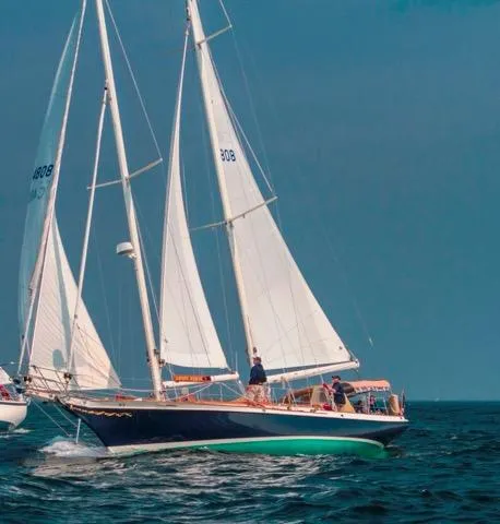 Slide: The Image of Cherubini Schooner 2000 sailing on open water with full sails. - 4