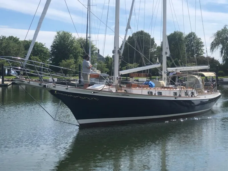 Slide: The Image of Cherubini Schooner 2000 sailing in calm waters, surrounded by lush greenery. - 7