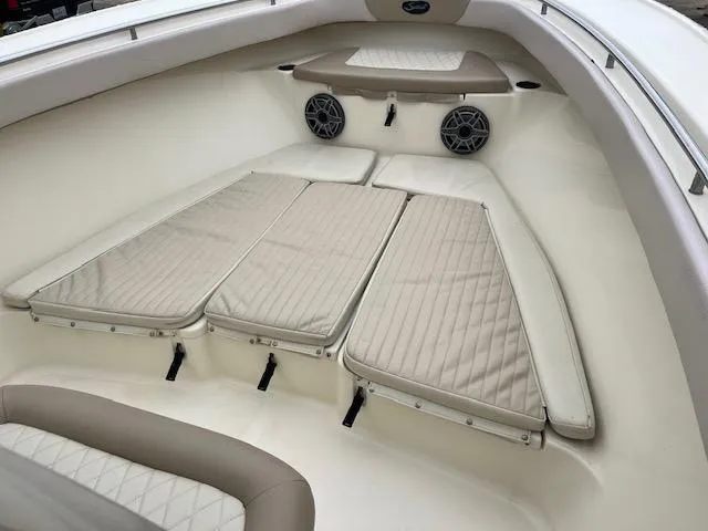 Slide: The Image of 2007 Scout 262 CC boat interior with cushioned seating and built-in speakers. - 10