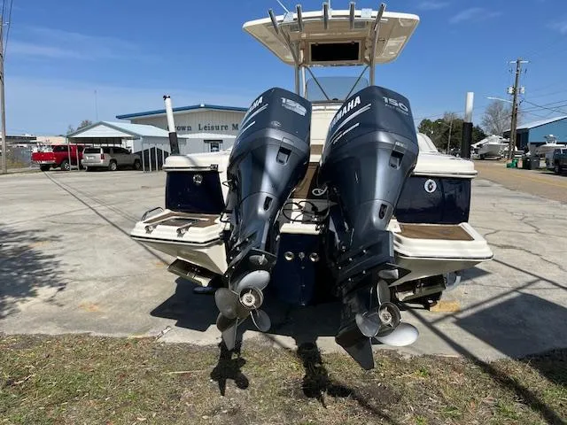 Slide: The Image of 2007 Scout 262 CC boat with dual Yamaha 150 engines, parked outdoors. - 3