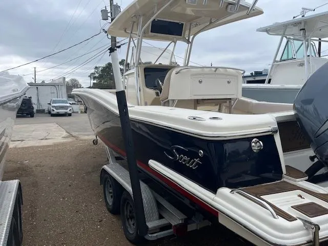Slide: The Image of 2007 Scout 262 CC boat on trailer, parked outdoors, featuring a sleek design and dual engines. - 4