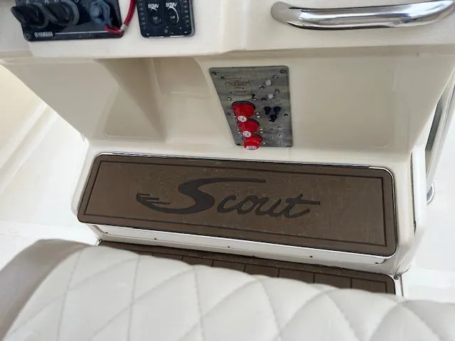 Slide: The Image of Control panel of a 2007 Scout 262 CC boat with logo and switches. - 7