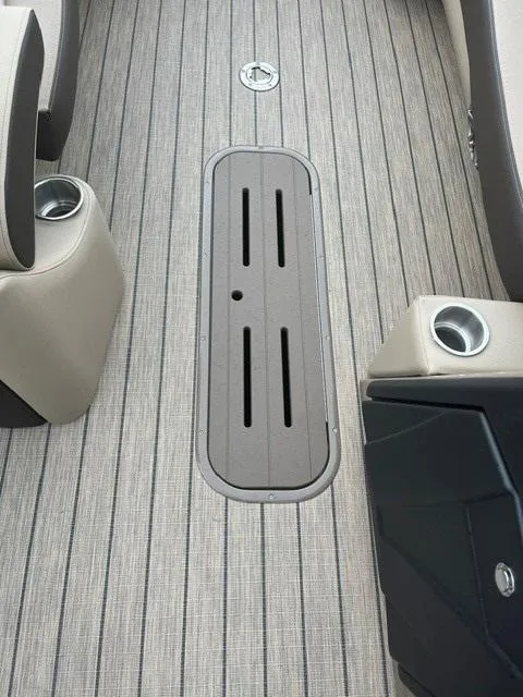 Slide: The Image of 2025 Veranda PV25RCT boat interior with sleek flooring and cup holders. - 11