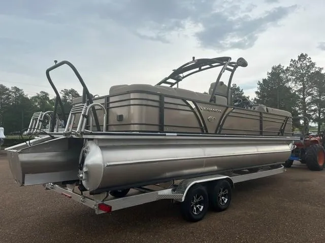 Slide: The Image of 2025 Veranda PV25RCT pontoon boat on trailer, parked outdoors. - 5