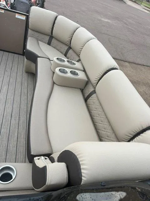 Slide: The Image of 2025 Veranda PV25RCT pontoon boat with luxurious beige seating and cup holders. - 7