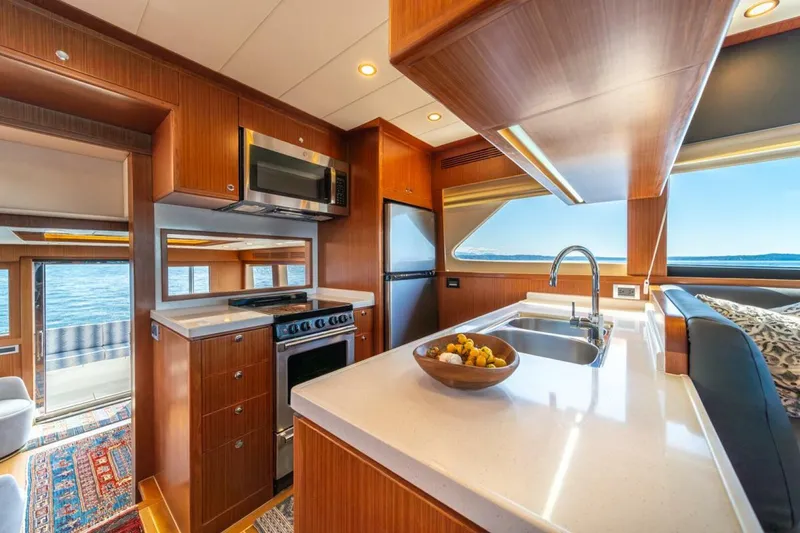 Slide: The Image of Luxurious kitchen interior of 2021 Apollonian Yachts 54 with modern appliances and ocean view. - 16