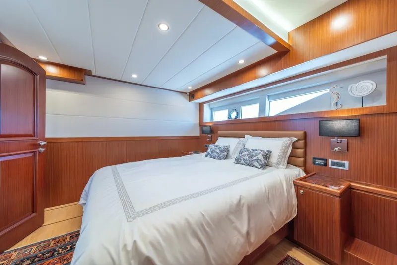 Slide: The Image of Luxurious bedroom interior on 2021 Apollonian Yachts 54, featuring elegant wood paneling and modern lighting. - 17