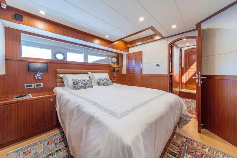 Slide: The Image of Luxurious bedroom interior of 2021 Apollonian Yachts 54, featuring elegant wood paneling. - 18