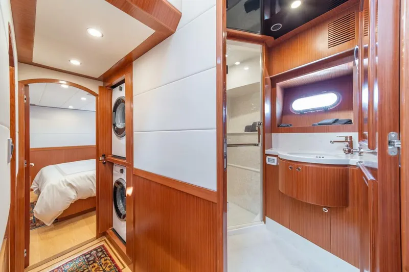 Slide: The Image of Interior of 2021 Apollonian Yachts 54, featuring bedroom, bathroom, and laundry area. - 26