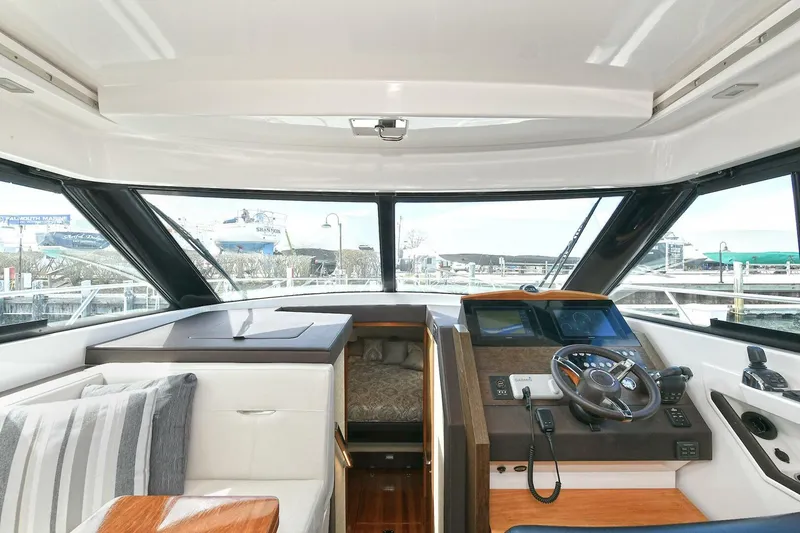 Slide: The Image of 2018 Tiara Yachts 39 Coupe interior with helm, seating, and panoramic windows. - 15