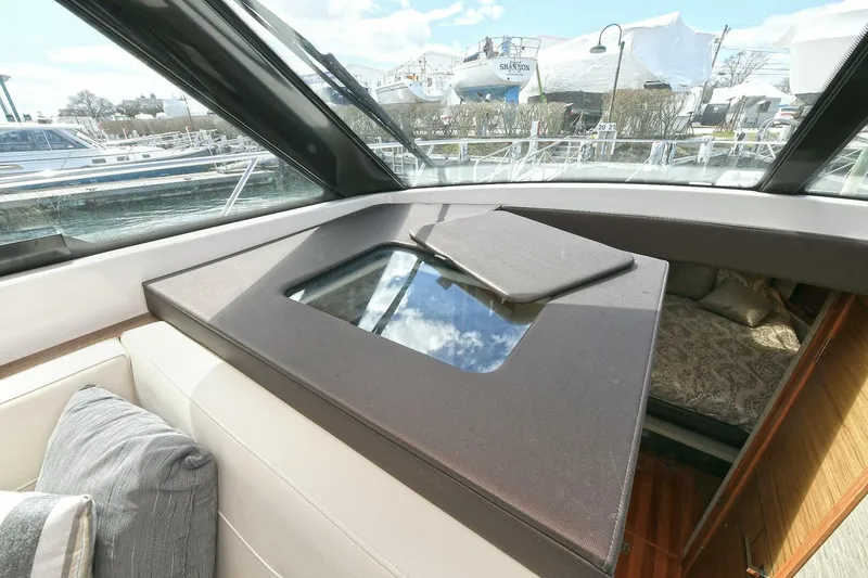 Slide: The Image of Interior view of 2018 Tiara Yachts 39 Coupe, featuring a skylight and luxurious seating. - 16