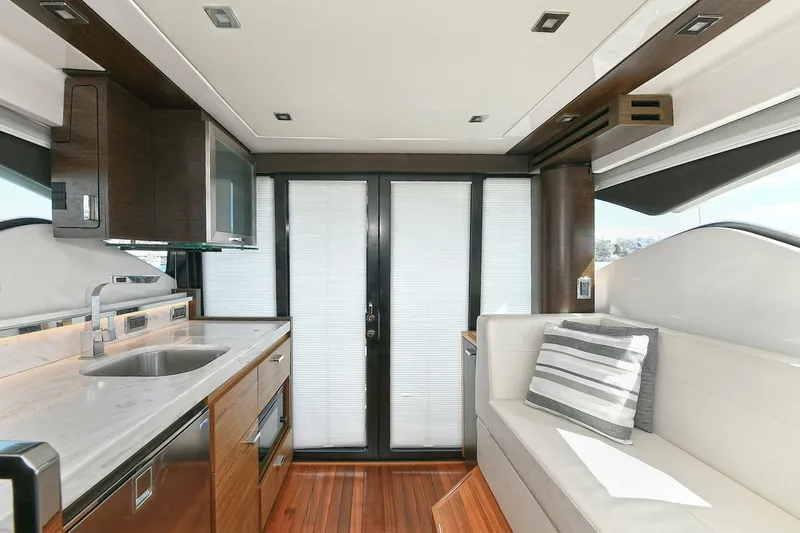 Slide: The Image of Interior of 2018 Tiara Yachts 39 Coupe with modern kitchen and seating area. - 20