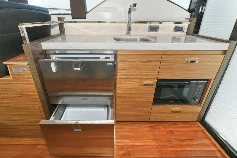 Slide: The Image of Modern kitchen area in 2018 Tiara Yachts 39 Coupe with stainless steel appliances. - 23