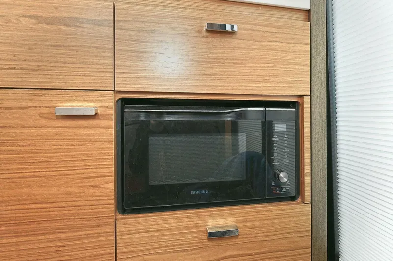Slide: The Image of Built-in microwave in Tiara Yachts 39 Coupe 2018, surrounded by wooden cabinetry. - 24