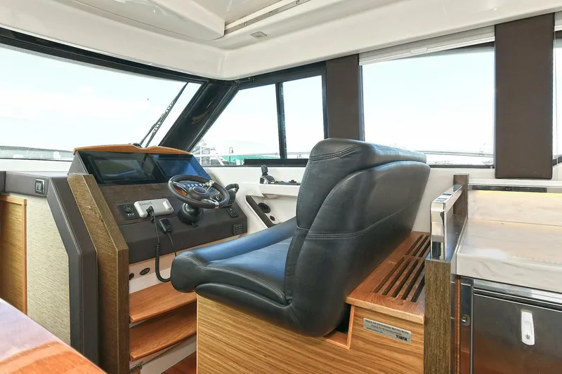 Slide: The Image of 2018 Tiara Yachts 39 Coupe helm with leather seat and modern controls. - 26