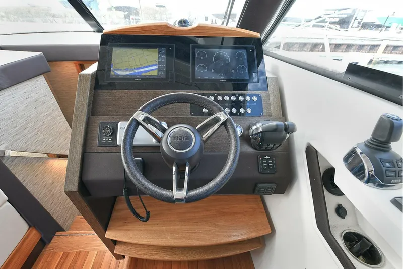 Slide: The Image of Helm of 2018 Tiara Yachts 39 Coupe with modern navigation controls and steering wheel. - 30