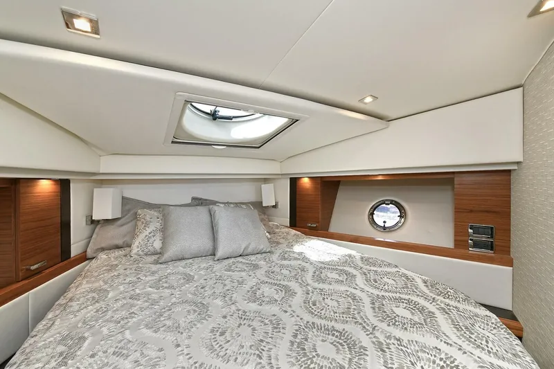 Slide: The Image of Luxurious bedroom interior of 2018 Tiara Yachts 39 Coupe with elegant bedding and porthole window. - 35