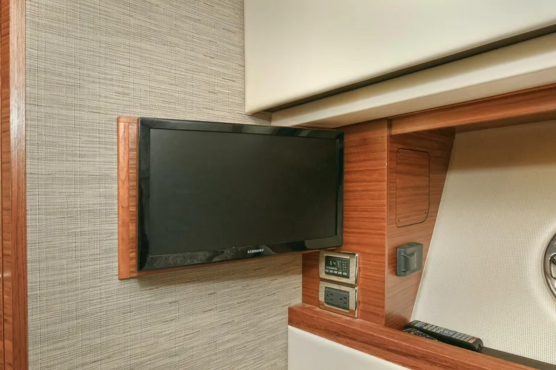 Slide: The Image of Interior of 2018 Tiara Yachts 39 Coupe featuring a mounted TV and control panel. - 37