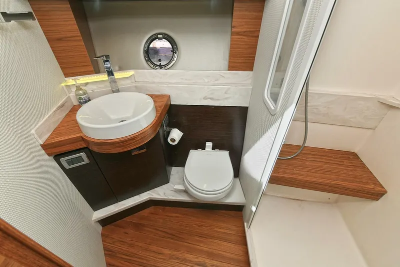 Slide: The Image of Luxurious bathroom in 2018 Tiara Yachts 39 Coupe with modern fixtures and wood accents. - 38