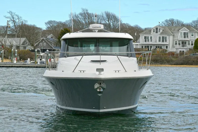 Slide: The Image of 2018 Tiara Yachts 39 Coupe on water, front view, near coastal homes. - 4