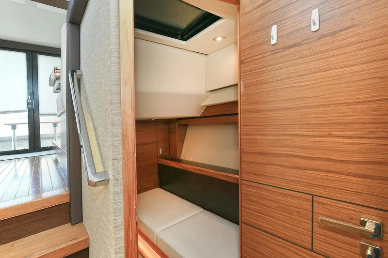 Slide: The Image of 2018 Tiara Yachts 39 Coupe interior cabin with wooden finishes and seating area. - 40