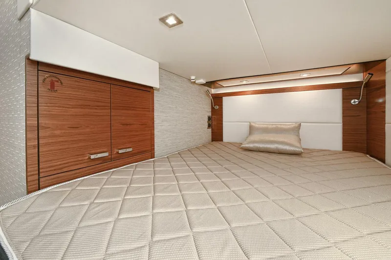 Slide: The Image of Luxurious cabin interior of 2018 Tiara Yachts 39 Coupe with elegant bedding and wood accents. - 42