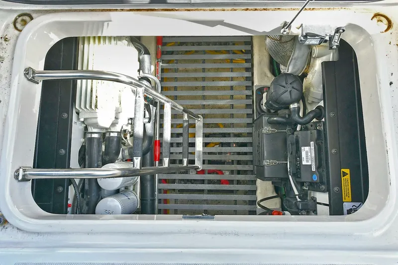 Slide: The Image of Engine compartment of 2018 Tiara Yachts 39 Coupe, showcasing mechanical components and ladder. - 44
