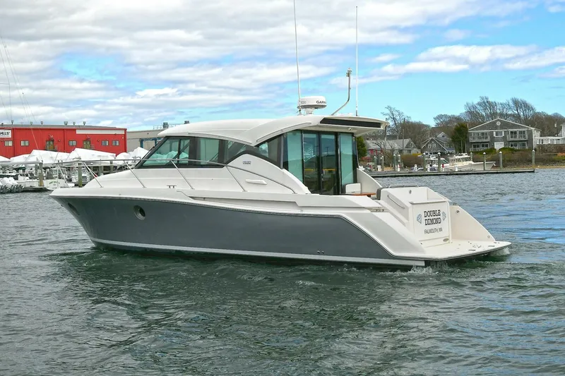 Slide: The Image of 2018 Tiara Yachts 39 Coupe cruising on a calm waterway, showcasing sleek design and luxury. - 5