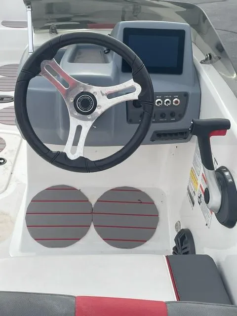 Slide: The Image of 2023 Tahoe T18 boat dashboard with steering wheel and control panel. - 7